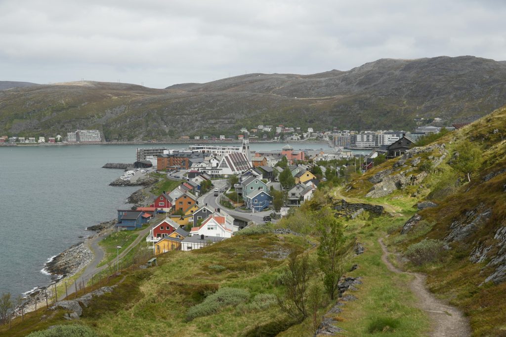 Explore the picturesque Hammerfest, Norway with charming houses along the fjord coastline.