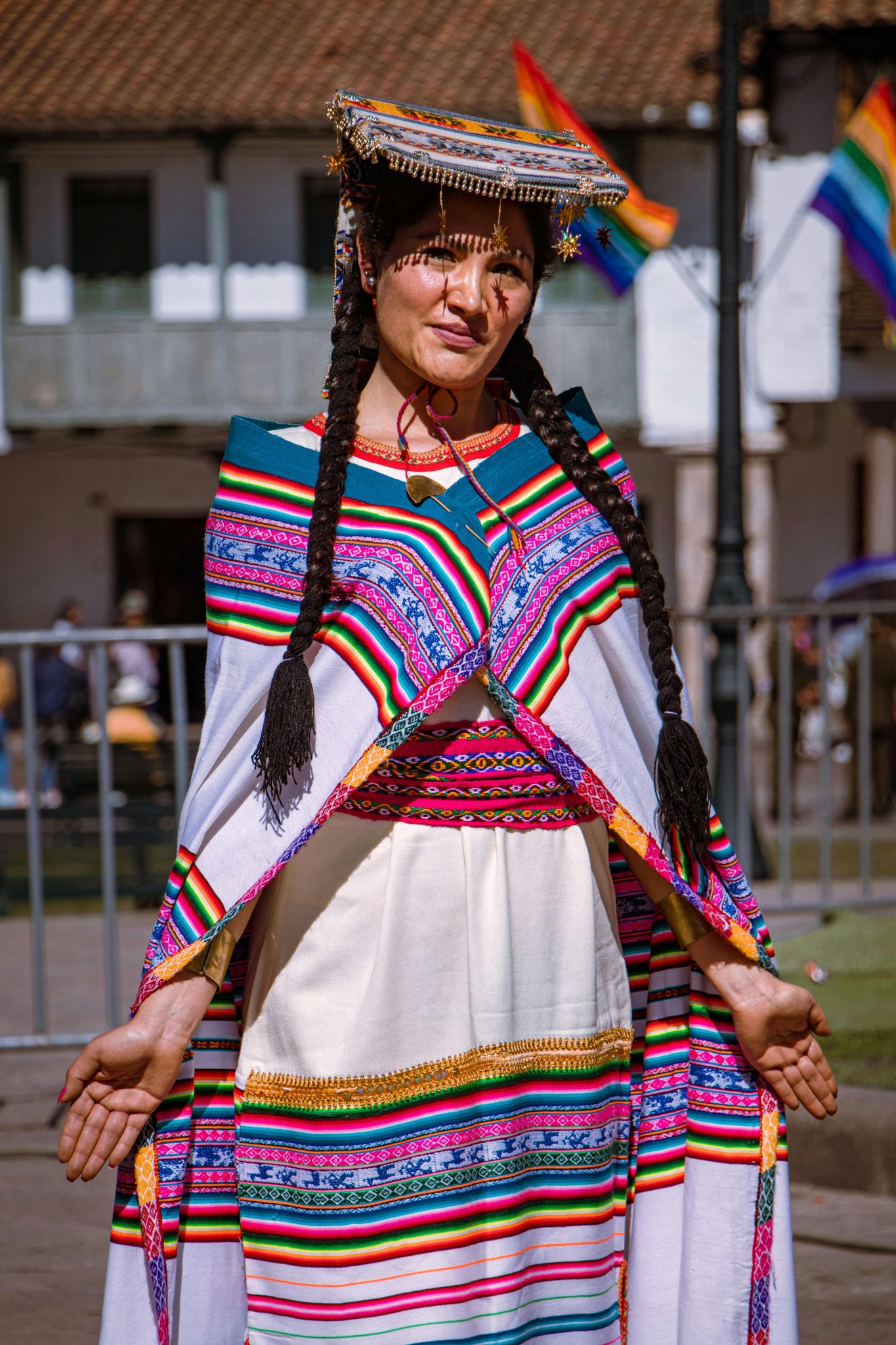 Woman in traditional Inti Raymi attire during a vibrant cultural parade in Cusco, Peru.