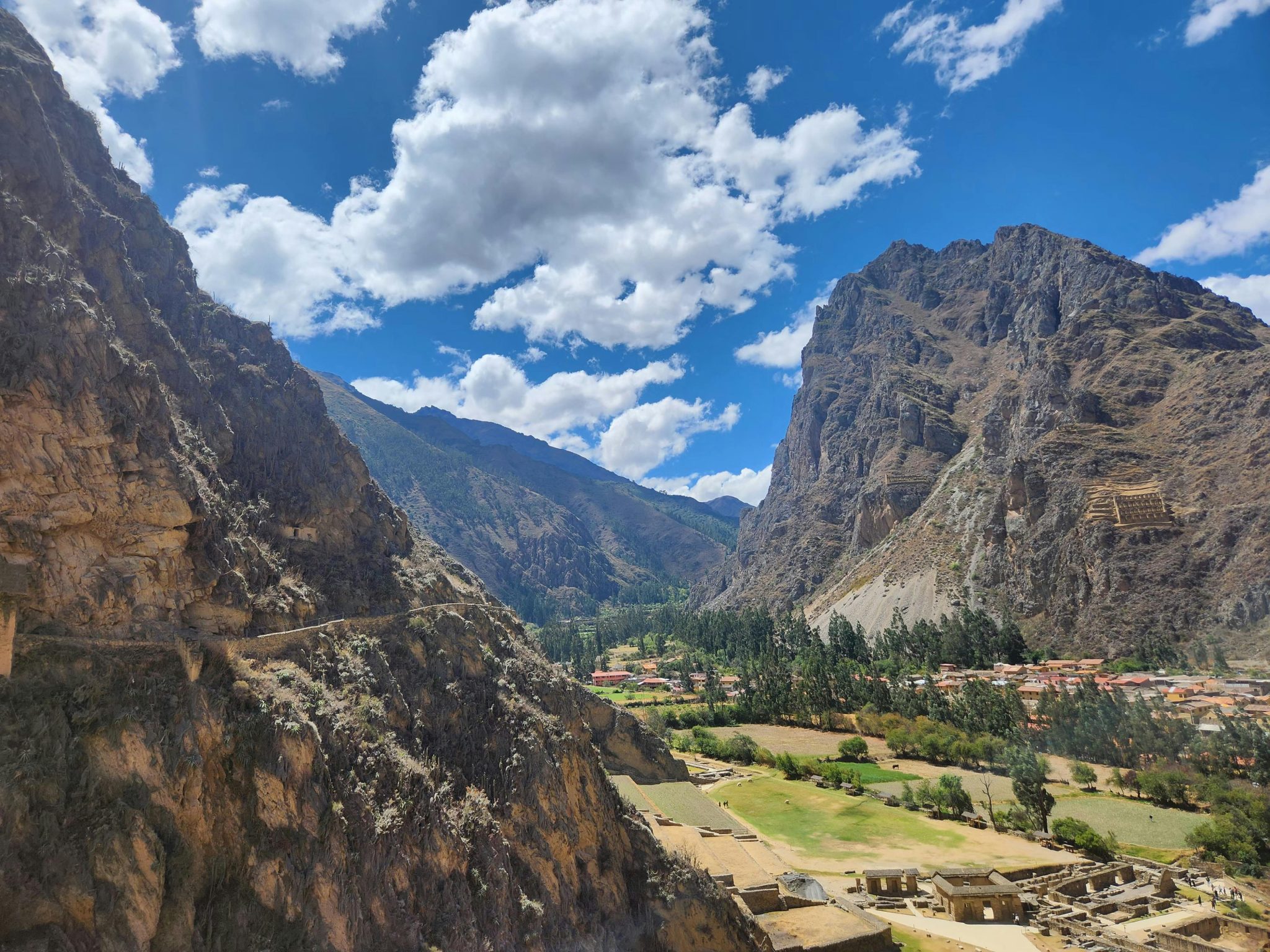 A stunning landscape of Ollantaytambo ruins against a majestic mountain backdrop.