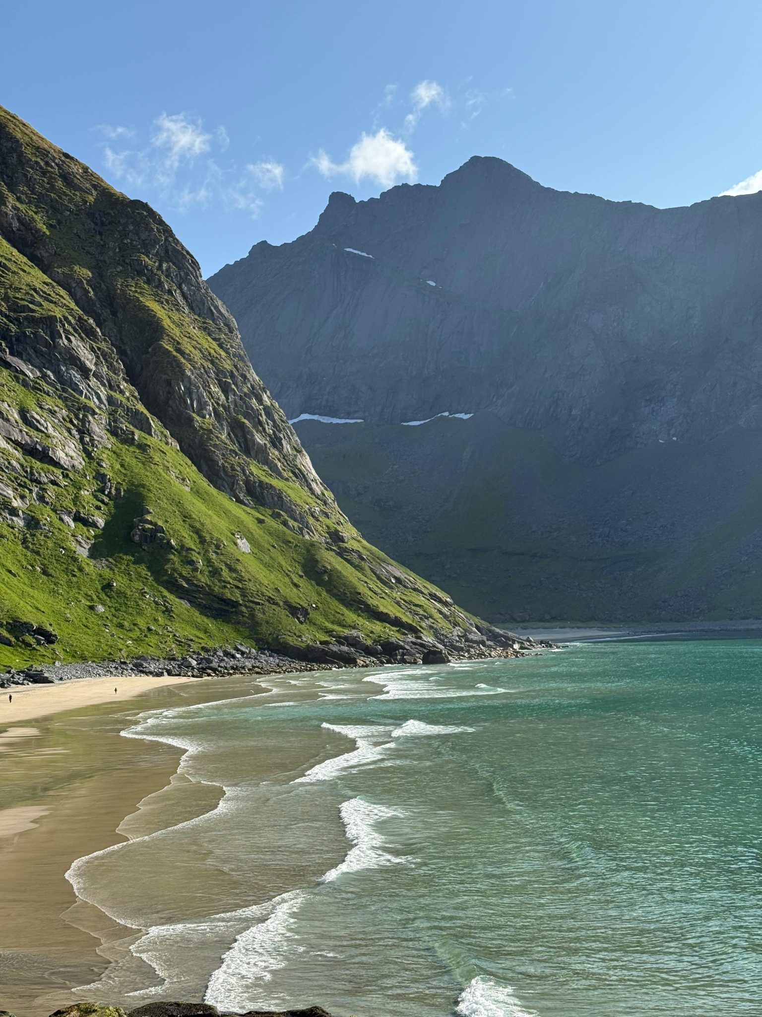 Experience the breathtaking coastal landscapes of Lofoten, Norway, with pristine beaches and majestic mountains.