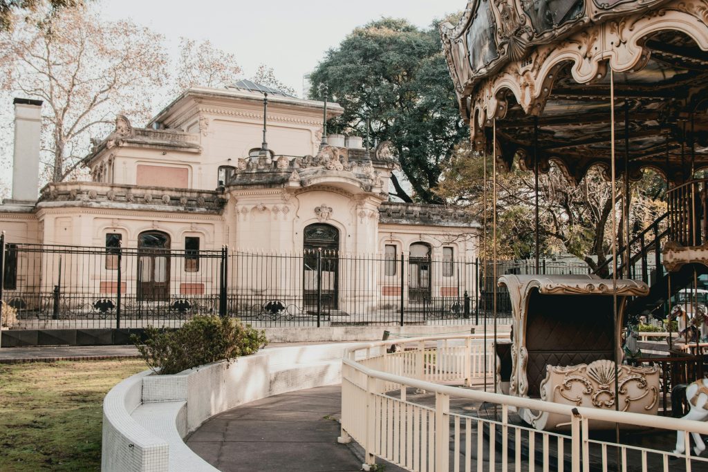 Vintage carousel beside a historical building in Buenos Aires, Argentina.